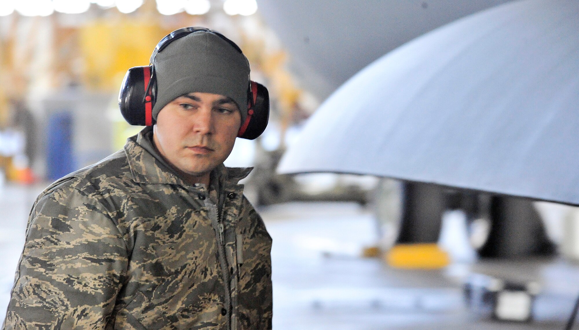 Airman Banks stands next to a C-17 as he looks back to check for tools that he might need. (U.S. Air Force photo/Airman 1st Class Jacob Morgan)