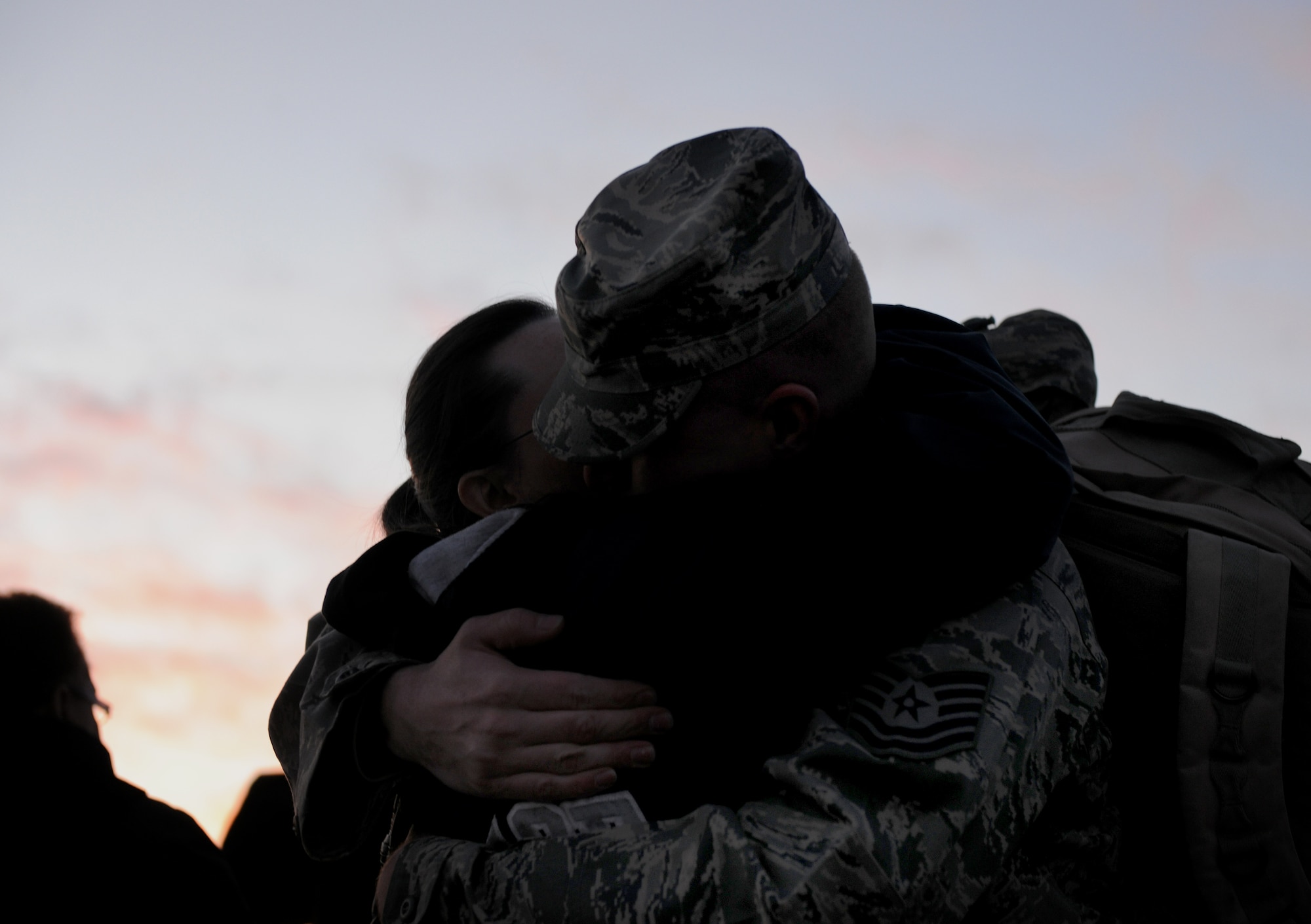 MOODY AIR FORCE BASE, Ga.-- Tech. Sgt. Jason Hera, 822nd Base Defense Squadron squad leader, gives his wife, Jennifer, a hug before boarding a charter bus Jan. 23. Family members and members from the 93rd Air Ground Operations Wing came out to see their fellow Airmen from the 822nd BDS deploy to Iraq. (U.S. Air Force photo/Airman 1st Class Benjamin Wiseman)(RELEASED)