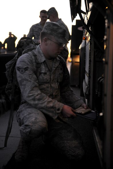 MOODY AIR FORCE BASE, Ga.-- Airman 1st Class Edward Huffman, 822nd Base Defense Squadron, loads his gear onto a charter Jan. 23. Airman Huffman and the other members of his squadron will travel to Iraq for a six-month deployment. (U.S. Air Force photo/Airman 1st Class Benjamin Wiseman)(RELEASED)