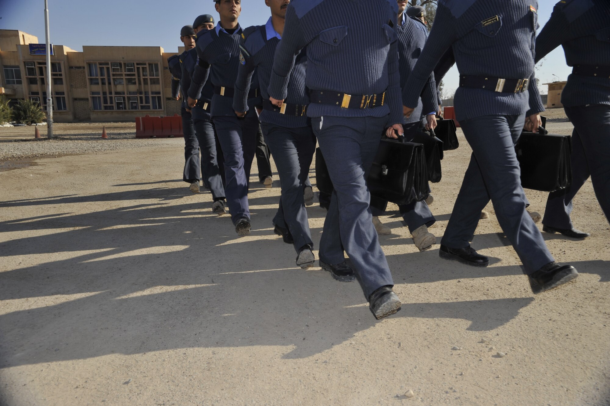Cadet pilots in Class 76 at the Iraqi Air Force College, Tikrit, Iraq, march to class outside an academic building on the school’s campus. 151 young men began training in Sept. 2010 as part of the first class at the recently reopened academy. The 3-year program lays the foundation for the future of self-sufficient air power in Iraq with studies in airmanship, English, avionics, and the theory of aviation. (U.S. Air Force photo by Senior Master Sgt. Larry Schneck/Released)