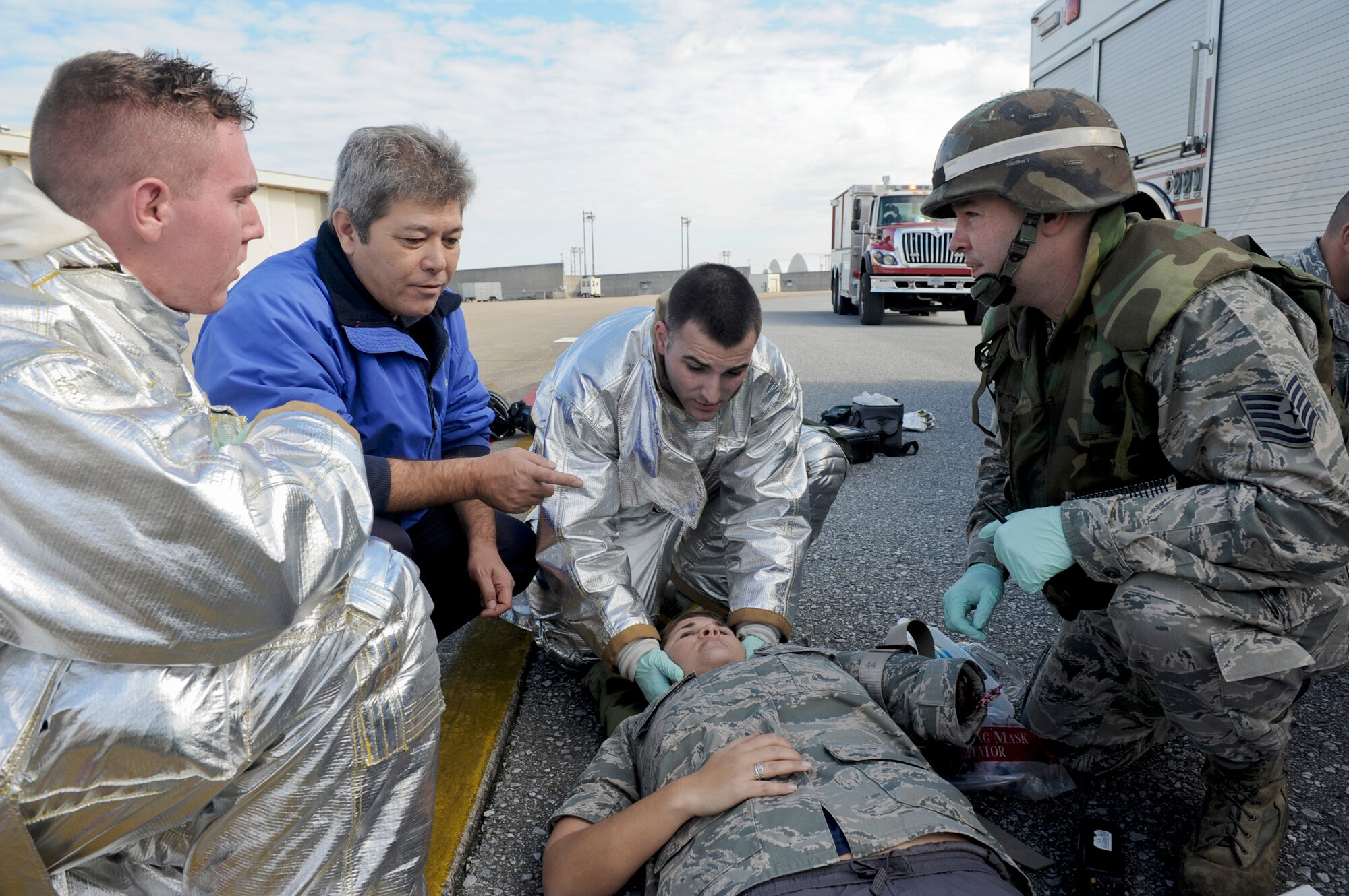 Firefighters from the 18th Civil Engineer Squadron treat a simulated victim from a simulated E-3 Sentry engine fire Jan. 19, 2011, at Kadena Air Base, Japan. The simulated engine fire was part of Beverly High 11-02, a Local Operational Readiness Exercise, and tested the firefighters' ability to respond to an aircraft fire. (U.S. Air Force photo/Staff Sgt. Jonathan Steffen)