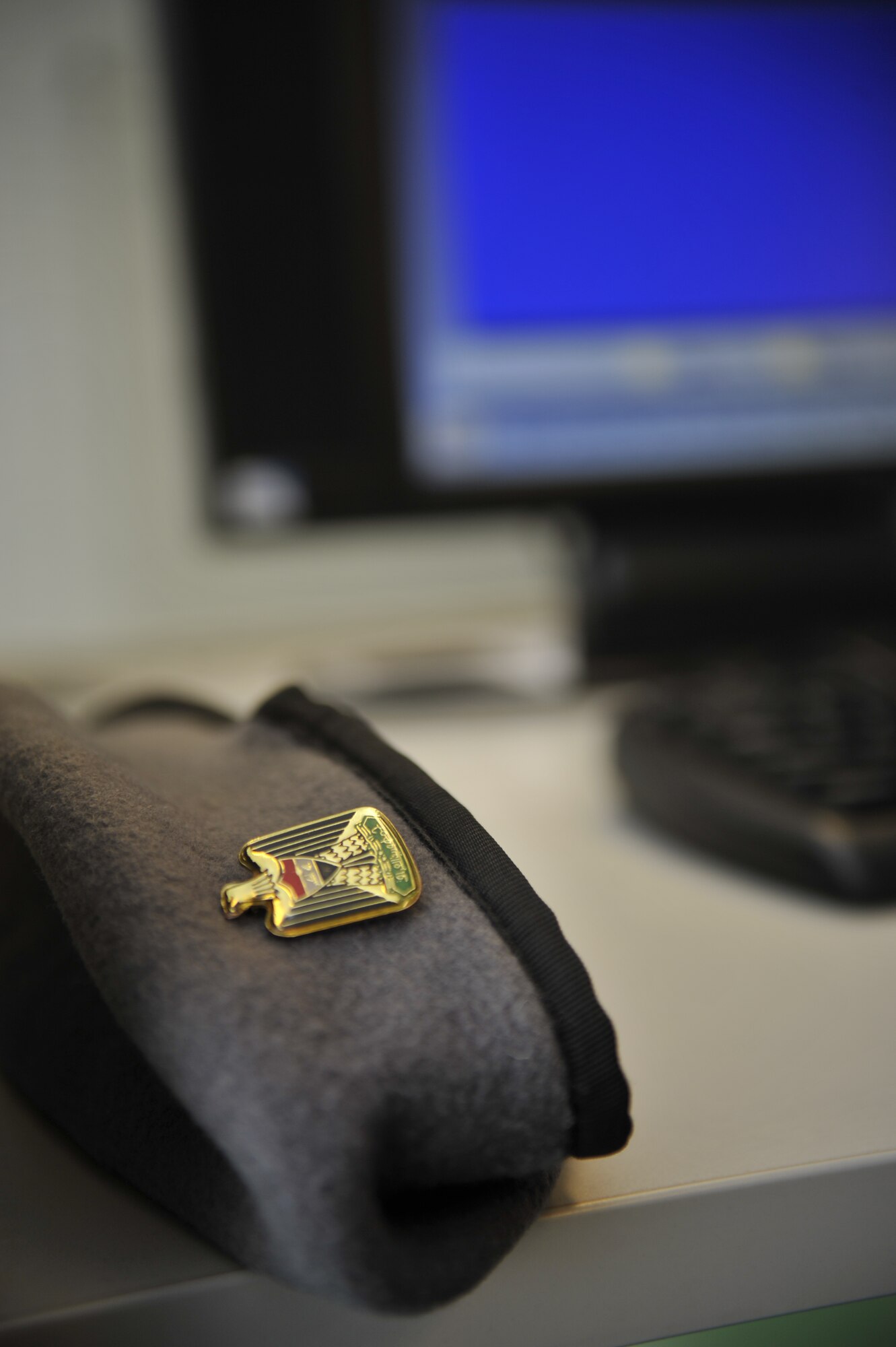 A cadet pilot's hat is shown in front of a computer screen inside the Iraqi Air Force College new American Language Course computer lab, Jan. 20 in Tikrit, Iraq. (U.S. Air Force photo by Senior Master Sgt. Larry Schneck/Released)