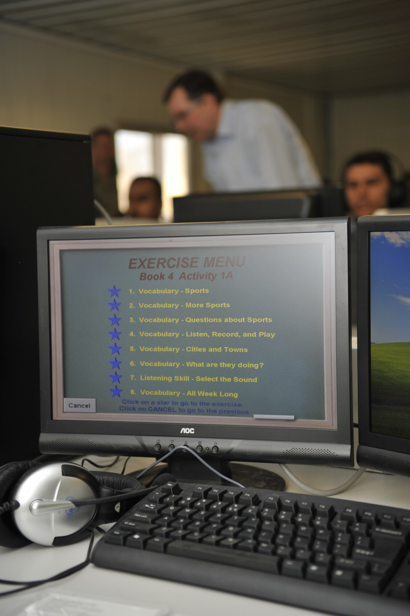 Robert Loebe, Iraqi Air Force College English language trainer, teaches a group of Iraqi cadet pilots inside the new American Language Course computer lab, Jan. 20. With assistance from the Defense Language Institute, English Language Center, San Antonio, Texas, the military academy located in Tikrit, Iraq, opened a computer lab as part of its English language training program. Mr. Loebe taught the first lessons to the students out of the modern $130,000 facility. (U.S. Air Force photo by Senior Master Sgt. Larry Schneck/Released)