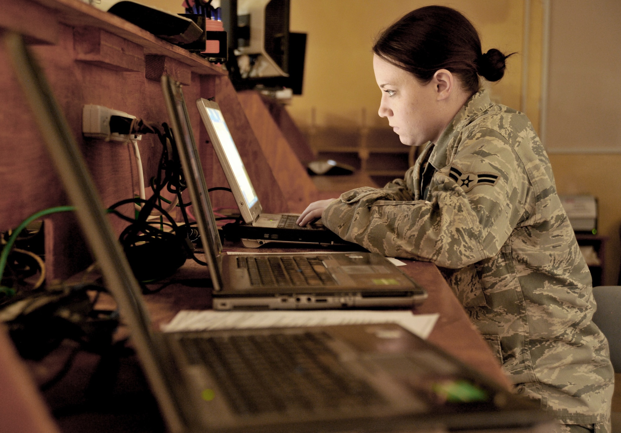 Airman 1st Class Sarah Taylor puts a customer's laptop on the domain Jan. 20, 2011, on COB Speicher, Iraq. Airman Taylor is an automated-data-processing and equipment technician for COB Speicher's direct-support-signal team. (U.S. Air Force photo/Senior Airman Andrew Lee)