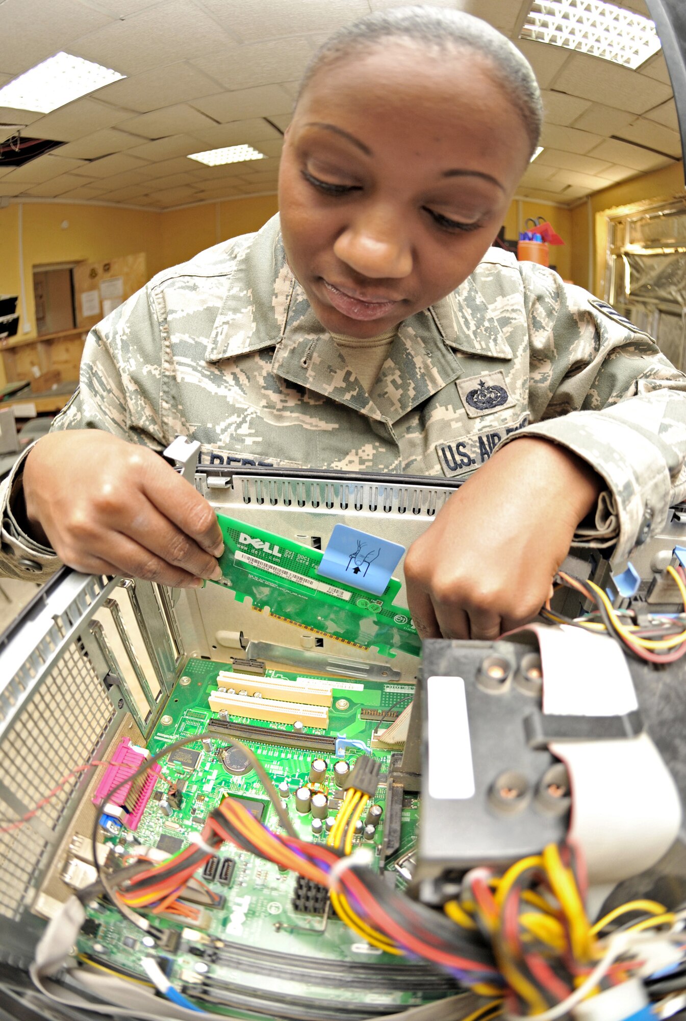 Staff Sgt. Gissell Gilbert pulls a video card from a desktop unit Jan. 24, 2011, on Contingency Operating Base Speicher, Iraq. Sergeant Gilbert is the automated-data-processing and equipment NCO in charge for COB Speicher's direct-support-signal team. (U.S. Air Force photo/Senior Airman Andrew Lee) 