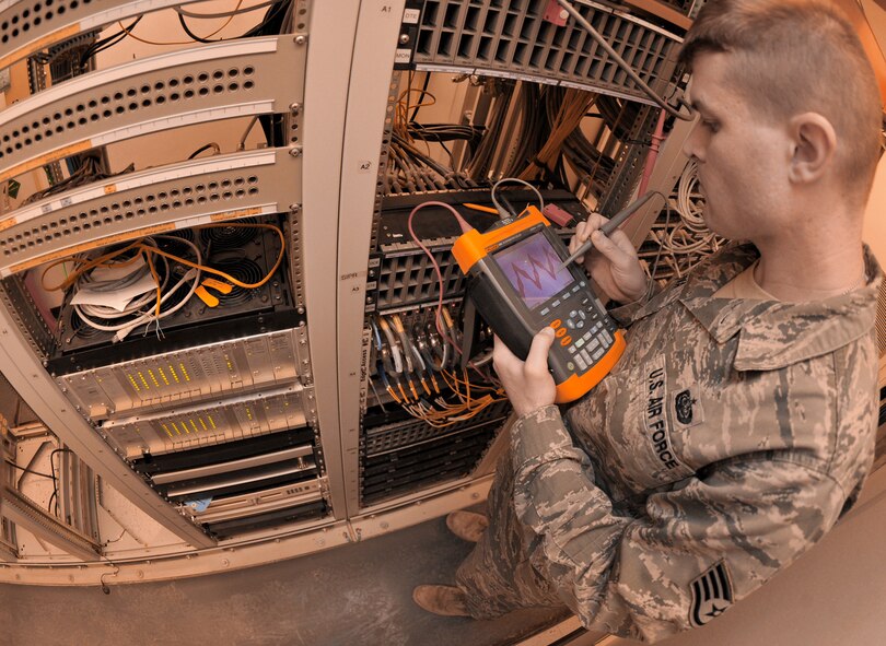 Staff Sgt. Tim Voliva looks at the signal strength of the facility through an oscilloscope Jan. 22, 2011, on Contingency Operating Base Speicher, Iraq. Sergeant Voliva is the technical-control-facility NCO in charge. (U.S. Air Force photo/Senior Airman Andrew Lee) 