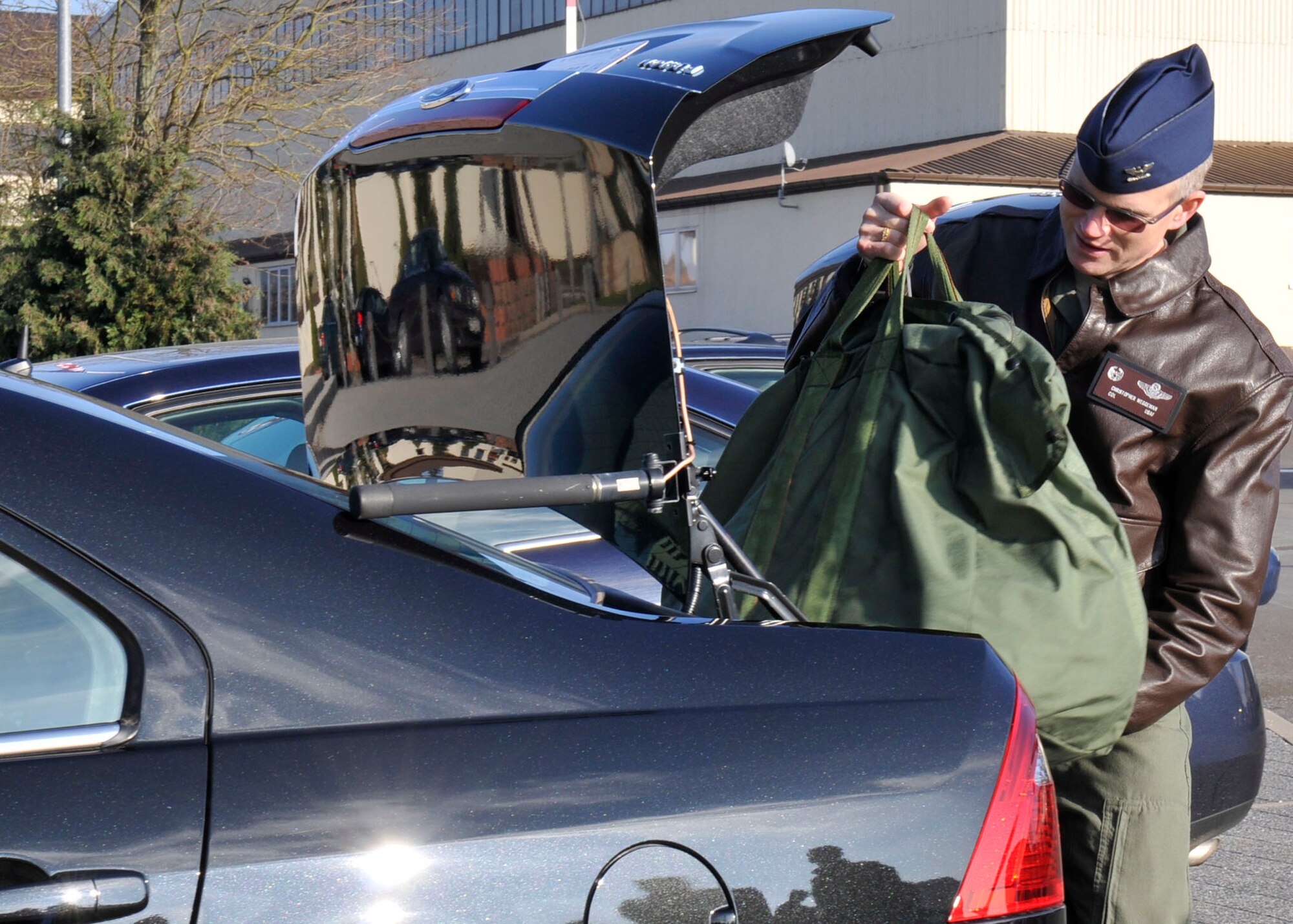 Col. Christopher Weggemen places his belongings in his hybrid Jan. 21, 2011, at Spangdahlem Air Base, Germany. Colonel Weggemen is the first person to drive a hybrid in the fleet at Spangdahlem AB, as a step toward the goal to comply with an executive order requiring a 34 percent reduction in greenhouse gas emissions by 2020 and 20 percent reduction of petroleum use by 2015. Colonel Weggemen is the 52nd Fighter Wing commander. (U.S. Air Force photo/Airman 1st Class Brittney Frees)