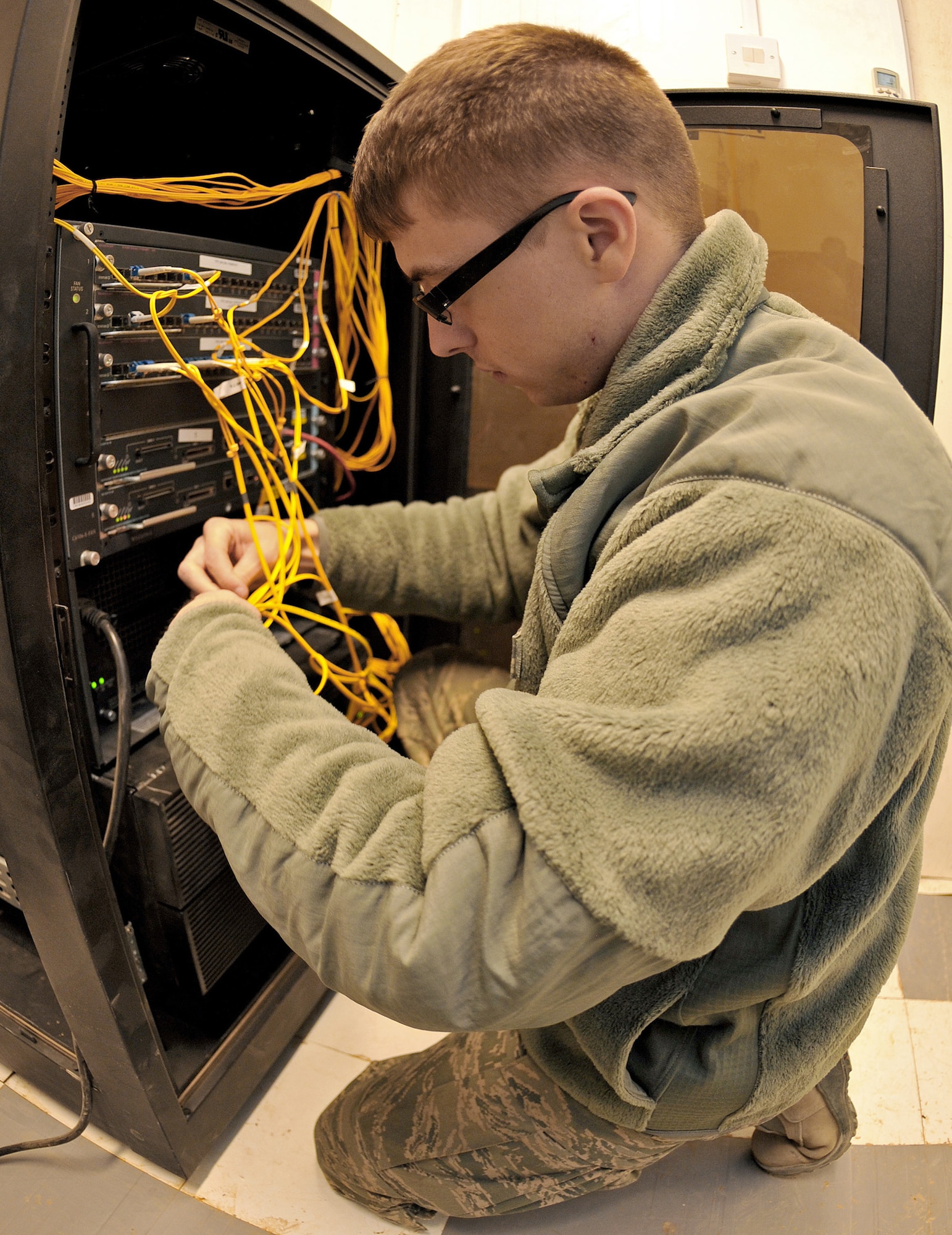 Senior Airman Raymond Harmon reorganizes wires inside an area distribution node Jan. 20, 2011, on Contingency Operating Base Speicher, Iraq. Airman Harmon is a COB Speicher direct-support-signal-team network administrator. (U.S. Air Force photo/Senior Airman Andrew Lee) 