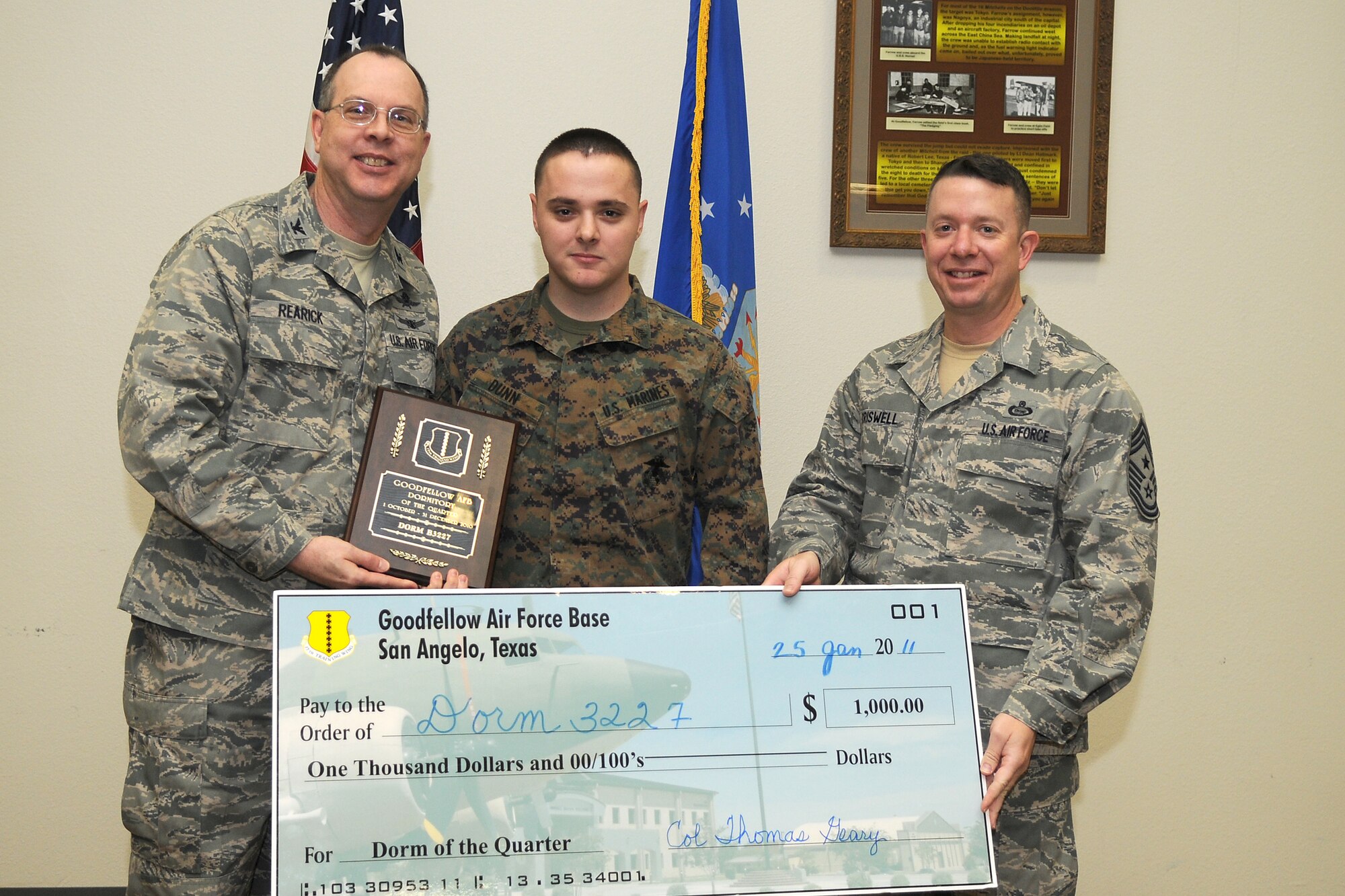 GOODFELLOW AIR FORCE BASE, Texas - Col. David Rearick, 17th Training Wing Vice Commander, and 17th TRW Command Chief, Chief Master Sgt. Brendan Criswell, present the Team Goodfellow Dormitory of the Quarter award to Marine Corps Dorm 3227 manager, Marine Sgt. Brandon Dunn, during the awards ceremony Jan. 25. (U.S. Air Force photo/Staff Sgt. Heather Rodgers)