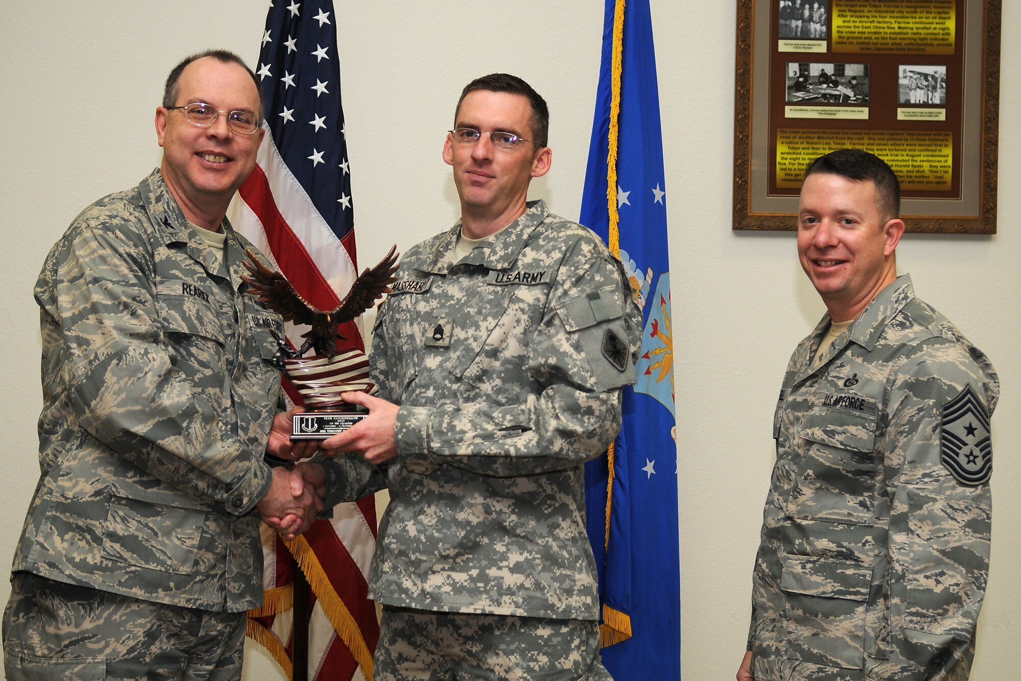 GOODFELLOW AIR FORCE BASE, Texas - Col. David Rearick, 17th Training Wing Vice Commander, and 17th TRW Command Chief, Chief Master Sgt. Brendan Criswell, present the Team Goodfellow NCO of the Quarter award to Army Staff Sgt. Timothy Masshardt, 344th Military Intelligence Battalion, during the awards ceremony Jan. 25. (U.S. Air Force photo/Staff Sgt. Heather Rodgers)