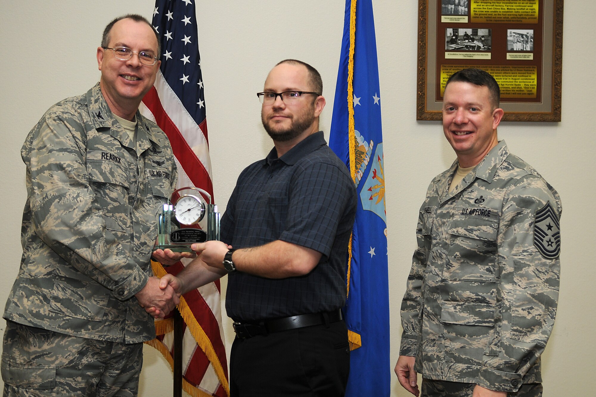 GOODFELLOW AIR FORCE BASE, Texas - Col. David Rearick, 17th Training Wing Vice Commander, and 17th TRW Command Chief, Chief Master Sgt. Brendan Criswell, present the Civilian Supervisor of the Quarter Category II award to Brian Codd, 17th Training Group, during the awards ceremony Jan. 25. (U.S. Air Force photo/Staff Sgt. Heather Rodgers)