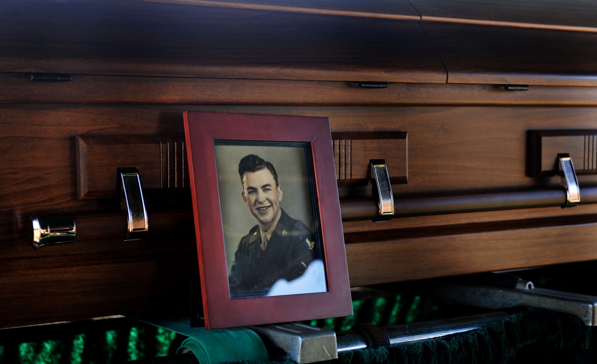 OZARK, Ala.-- A picture of 1st Lt. Robert Franklin Dees, a F-84E Thunderjet fighter pilot whose aircraft was shot down over North Korea in 1952 during a combat mission, sits on his casket at the end of his memorial ceremony Jan. 22. The ceremony and return of Lieutenant Dees remains provided long-awaited closure for his family. (U.S. Air Force photo/Airman 1st Class Joshua Green)(RELEASED)

