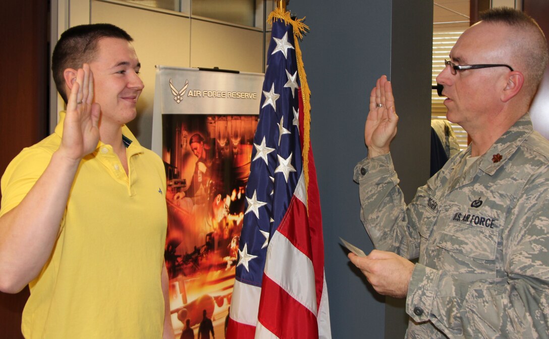 Andrew Fairchild repeats the oath of enlistment from Maj. Stan Paregien, public affairs officer of the 932nd Airlift Wing.  Fairchild joined the Air Force Reserve on Jan. 25 and will be trained as a pharmacy technician.  Previously, Fairchild served four years of active duty with the U.S. Navy.  (U.S. Air Force photo/Tech. Sgt. Dan Oliver) 