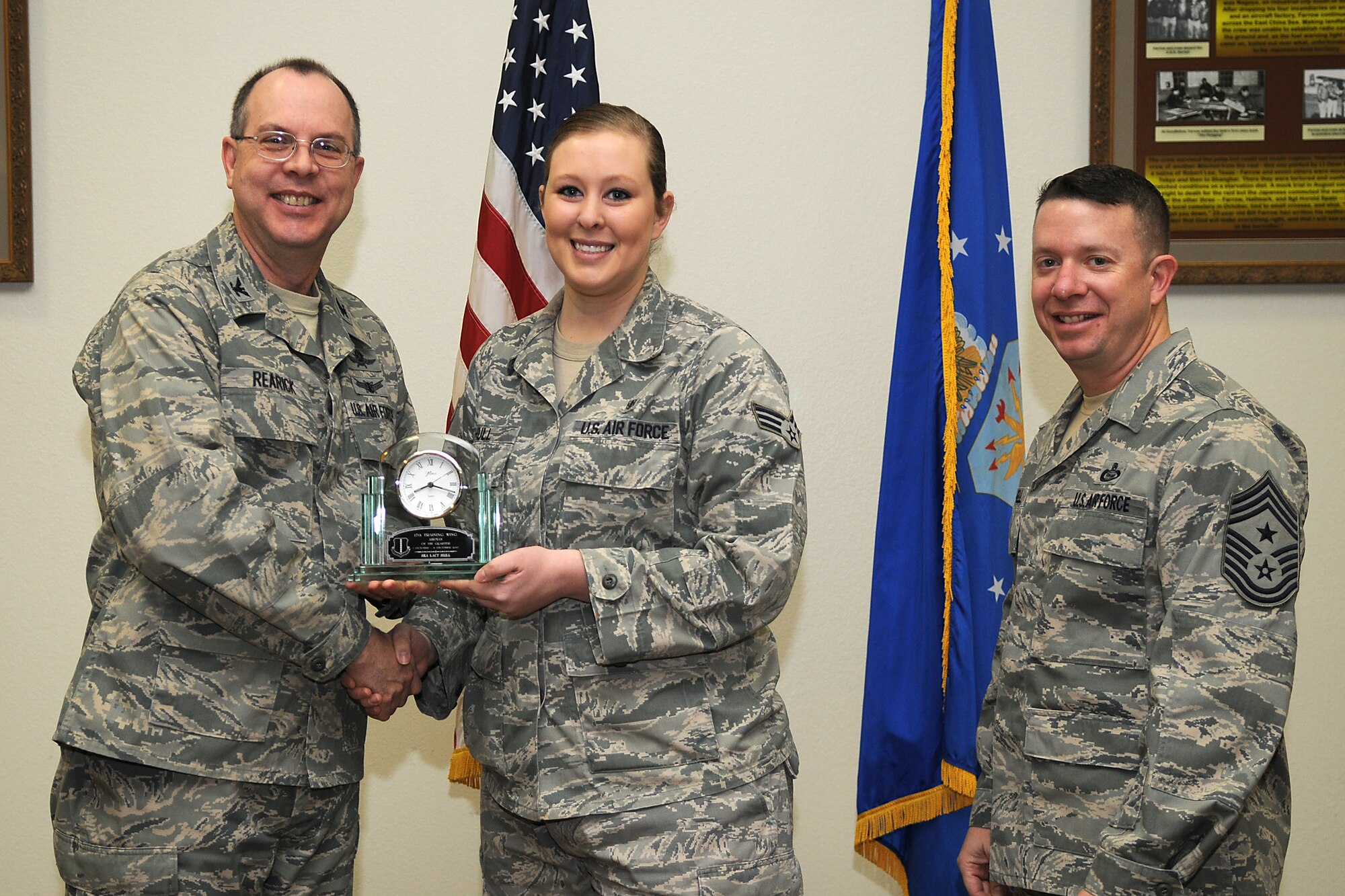 GOODFELLOW AIR FORCE BASE, Texas - Col. David Rearick, 17th Training Wing Vice Commander, and 17th TRW Command Chief, Chief Master Sgt. Brendan Criswell, present the Airman of the Quarter award to Senior Airman Lacy Hull, 17th Medical Group, during the awards ceremony Jan. 25. (U.S. Air Force photo/Staff Sgt. Heather Rodgers)
