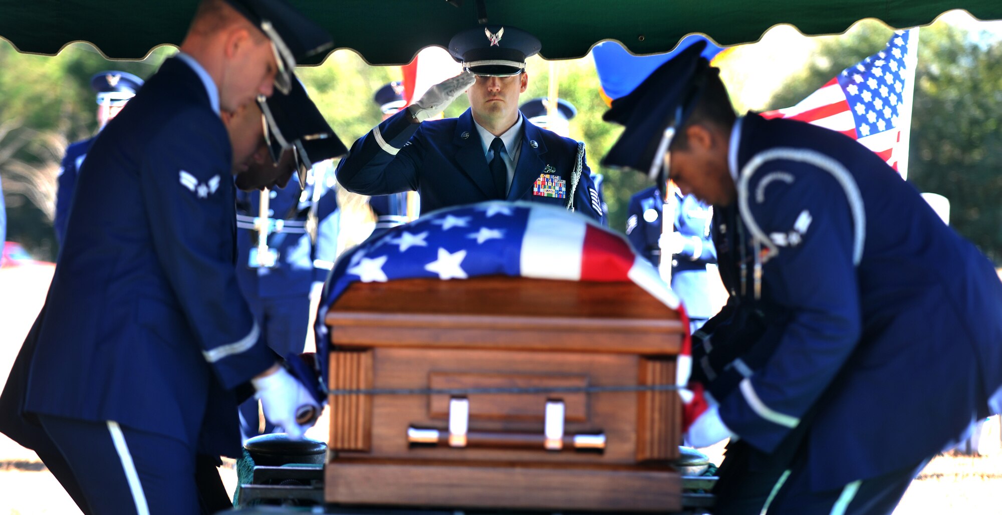 OZARK, Ala.-- Tech. Sgt Troy Kiick, Honor Guard NCO from Eglin Air Force Base, Fl., renders a salute to the casket of 1st Lt. Robert Franklin Dees, while other members of the Honor Guard remove the flag from the casket Jan. 22. The Honor Guard from Eglin AFB provided their support during the memorial service held for Lieutenant Dees, a 430th Fighter-Bomber Squadron, 474th Fighter Bomber Group Thunderjet F-84E fighter pilot whose aircraft was shot down over North Korea in 1952 during a combat mission. His remains were overseas for more than half a century before being brought home to be laid to rest next to his family members. (U.S. Air Force photo/Airman 1st Class Joshua Green)(RELEASED)
