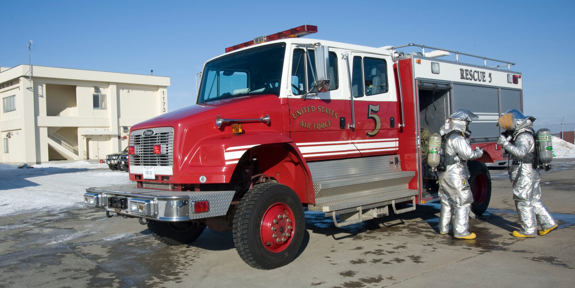 U.S. Air Force Airmen from the 35th Civil Engineer Squadron respond to a call from Bldg. 1173 during an operational readiness exercise at Misawa Air Base, Japan, Jan. 25, 2011. The building was hit by a simulated missile attack as part of the training exercise, testing Airmen’s ability to survive and operate during contingency operations.  (U.S. Air Force photo by Tech. Sgt. Russell McBride/Released)