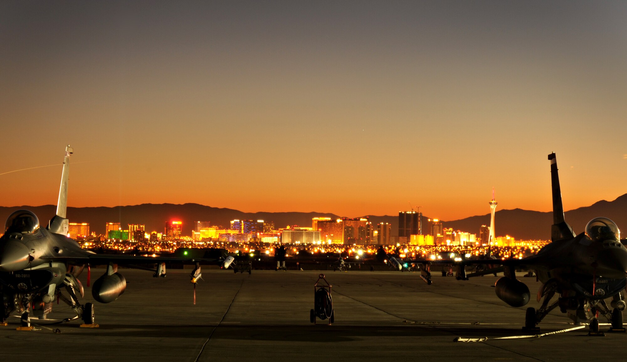 NELLIS AIR FORCE BASE, Nev. -- F-16 Fighting Falcons deployed from the 480th Fighter Squadron, Spangdahlem Air Base, Germany, sit on the flightline in front of the Las Vegas skyline Jan. 22 before the beginning of Red Flag 11-2. Red Flag is a combined exercise that provides a realistic combat training environment to the U.S. and its allies. (U.S. Air Force photo/Staff Sgt. Benjamin Wilson)
