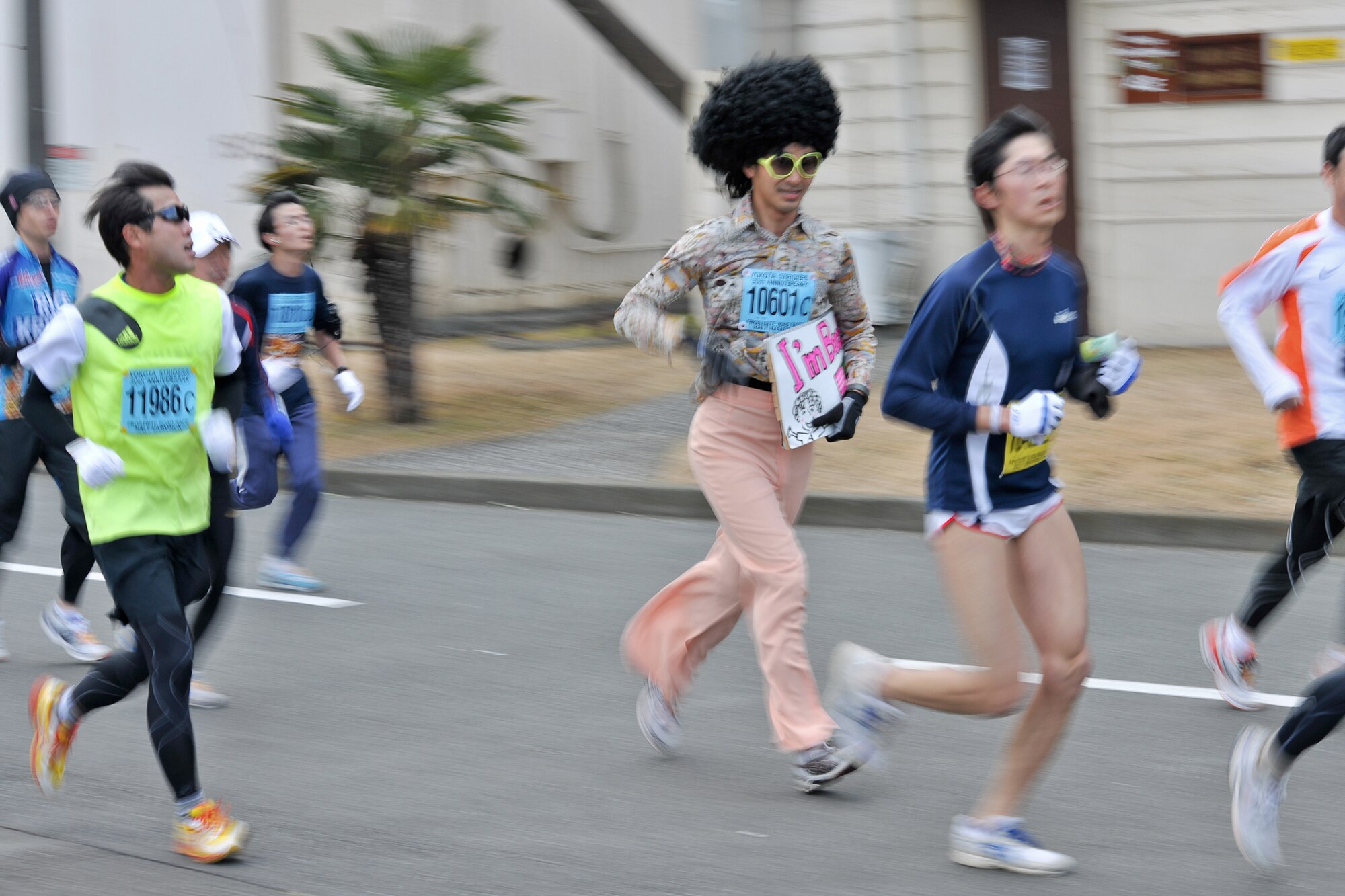 A runner dressed as a 1970s disco attire participates in the 30th Annual Frostbite Road Race Jan. 16, 2011, at Yokota Air Base, Japan. Some of the 6,000 runners who participated chose to wear costumes, an act that has become a yearly tradition. (U.S. Air Force photo/Osakabe Yasuo)