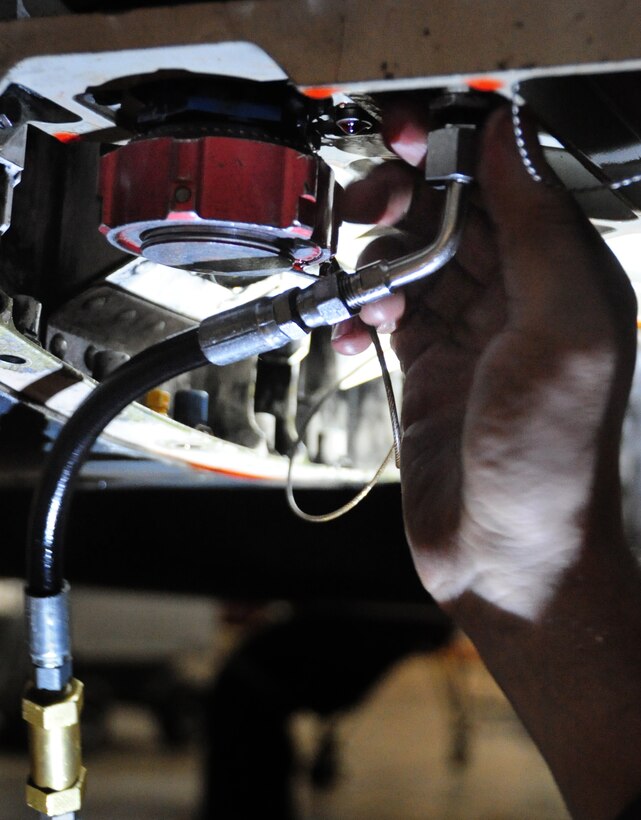 Airman 1st Class Zachery Brackeen, 28th Aircraft Maintenance Squadron crew chief, services the Cn2 hydraulic system on the B-1B Lancer engine at Ellsworth Air Force Base, S.D., Jan. 21.  The Cn2 system runs all of the hydraulics on the aircraft and is maintained and refilled as needed to ensure the proper flow of fluids. (U.S. Air Force photo/Senior Airman Anthony Sanchelli)
