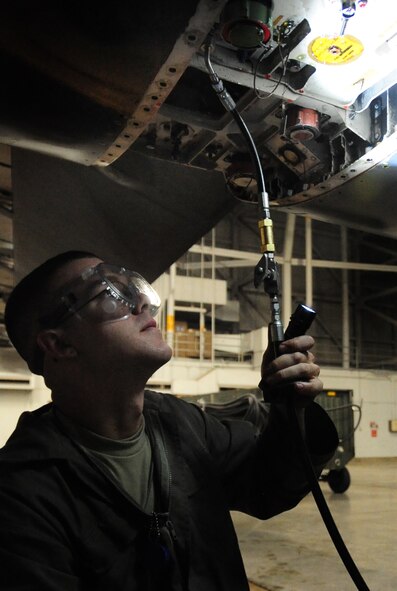 Airman 1st Class Zachery Brackeen, 28th Aircraft Maintenance Squadron crew chief, services the Cn2 hydraulic system on the B-1B Lancer engine at Ellsworth Air Force Base, S.D., Jan. 21.  The Cn2 system runs all of the hydraulics on the aircraft and is maintained and refilled as needed to ensure the proper flow of fluids. (U.S. Air Force photo/Senior Airman Anthony Sanchelli)