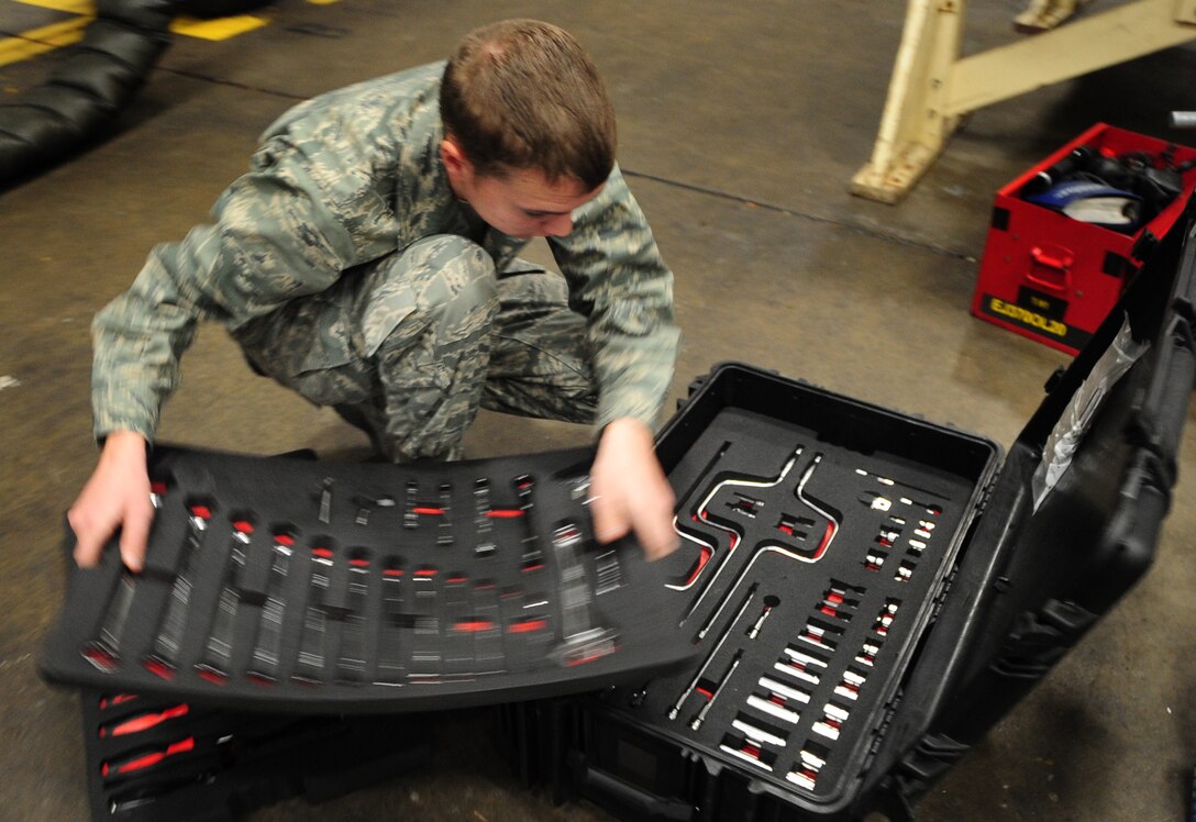 Airman Mark Vadnais, 28th Aircraft Maintenance Squadron able chief, searches for the correct tool before conducting maintenance on the B-1B Lancer at Ellsworth Air Force Base, S.D., Jan. 21.  Airman Vadnais is participating in an on-the-job training course involving 22 academic days, consisting of 108 hours of training, to become a crew chief for the B-1. (U.S. Air Force photo/Senior Airman Anthony Sanchelli)
