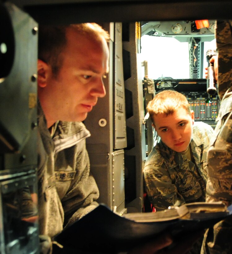 (Right to left) Airman Mark Vadnais, 28th Aircraft Maintenance Squadron able chief, learns which switches to activate or deactivate before conducting B-1B Lancer maintenance from Staff Sgt. Chris Dieball, 28th AXMS crew chief instructor, at Ellsworth Air Force Base, S.D., Jan. 21.  Knowing which buttons and switches to push is crucial when dealing with the multi-million dollar aircraft. (U.S. Air Force photo/Senior Airman Anthony Sanchelli)