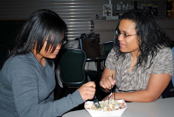 Senior Airman Tambara Hamilton, a 341st Medical Support Squadron lab technician (left), and Senior Airman Shaleena Pulliam, a 341st Medical Operations Squadron dental assistant, share a salad for dinner.  Outside of their work they spend all the time they can together. (U.S. Air Force photo/Airman Cortney Hansen)