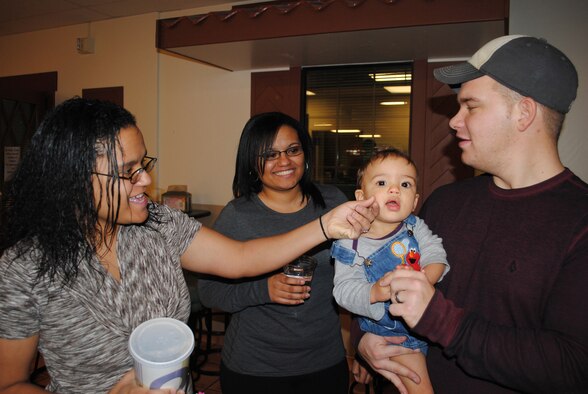 From left to right: Senior Airmen Shaleena Pulliam, a 341st Medical Operations Squadron dental assistant, Tambara Hamilton, a 341st Medical Support Squadron lab technician, and Brian Pulliam, a 341st Civil Engineer Squadron power production technician, entertain Kai, Brian and Shaleena's 1-year-old son.   After getting married to Airman Brian Pulliam, Airman Shaleena Pulliam took a joint-spouse assignment to Malmstrom, and is now stationed here with her twin sister. (U.S. Air Force photo/Airman Cortney Hansen)