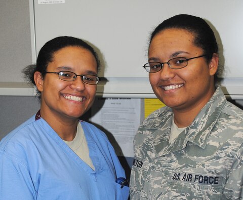 Senior Airman Shaleena Pulliam, a 341st Medical Operations Squadron dental assistant (left), and Senior Airman Tambara Hamilton, a 341st Medical Support Squadron lab technician, pose for a picture at work.  Although they are fraternal twins, they are commonly mistaken for each other when they're apart. (U.S. Air Force photo/Airman Cortney Hansen)