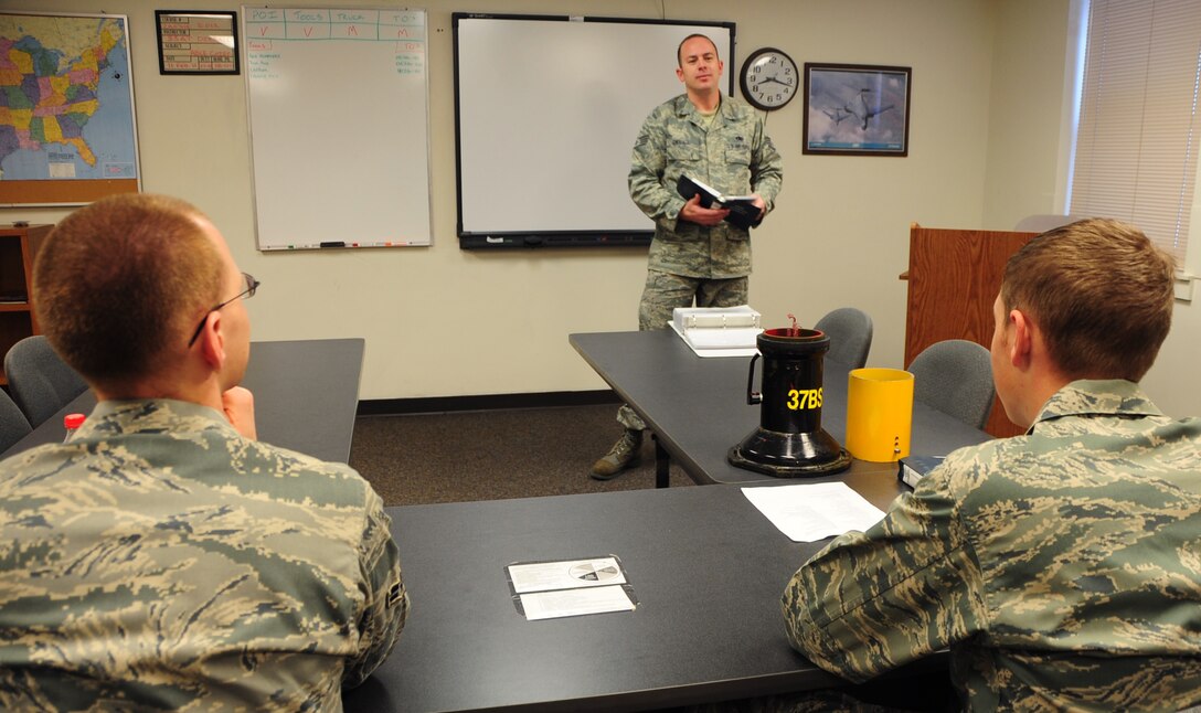 (Left to right) Airman 1st Class Christian Mains and Airman Mark Vadnais, 28th Aircraft Maintenance Squadron able chiefs, learn safer maintenance techniques from Staff Sgt. Chris Dieball, 28th AMXS crew chief instructor, at Ellsworth Air Force Base, S.D., Jan. 21.  B-1B Lancer able chief Airmen must attend 22 academic days, consisting of 108 hours of training before becoming a true crew chief. (U.S. Air Force photo/Senior Airman Anthony Sanchelli)