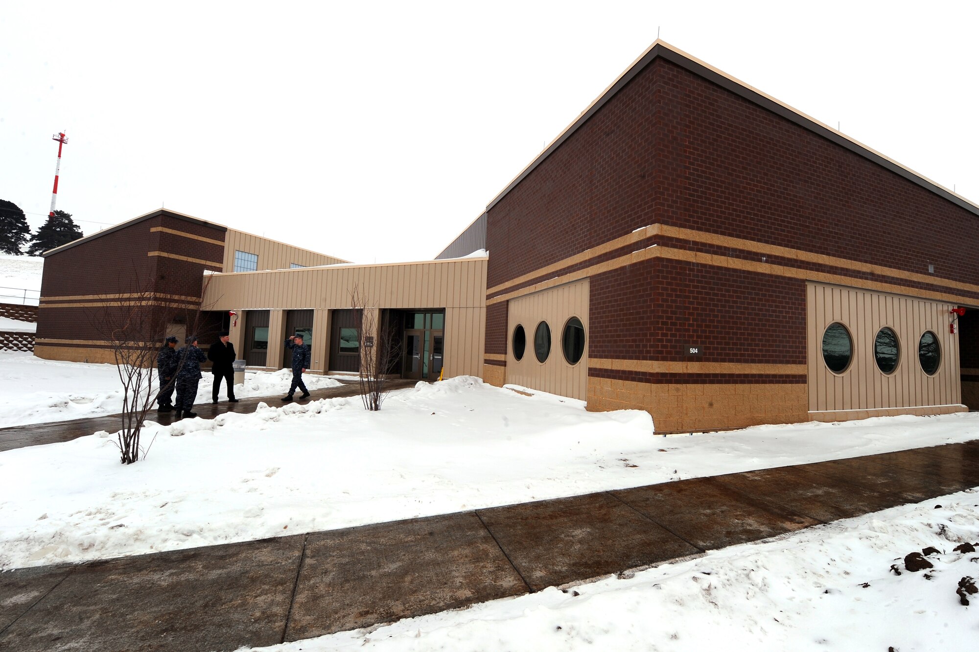 OFFUTT AIR FORCE BASE, Neb. - Sailors stand outside the newly constructed Navy Operational Support Center located here, January 22.   The 19,000-square foot, $4.3 million NOSC is now located behind Offutt's gates from its previous location in North Omaha, were it has been since 1965. U.S. Air Force Photo by Josh Plueger (released)
