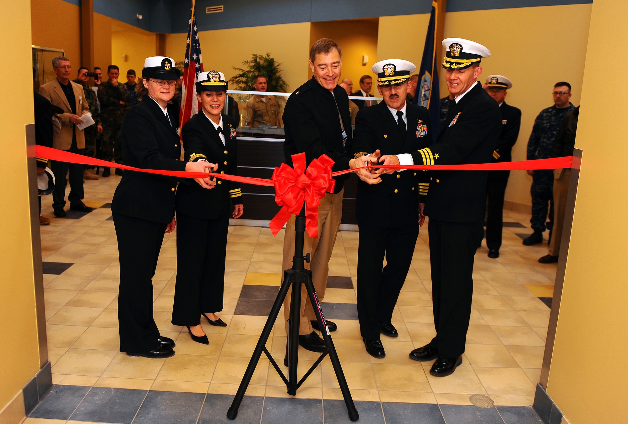 OFFUTT AIR FORCE BASE, Neb. - From left to right, Navy Master Chief Petty Officer Carrie R. Purgett, Navy Lt. Cmdr. Leticia Soto, Navy Rear Adm. Fritz Roegge, Navy Capt. Kevin Hempel and Navy Cmdr. Lanny G. Johnston perform the ribbon cutting at the newly constructed Navy Operations Center located here, Jan. 22. The 19,000-square foot, $4.3 million NOSC is now located behind Offutt's gates from its previous location in North Omaha, were it has been since 1965. U.S. Air Force Photo by Josh Plueger (released) 
