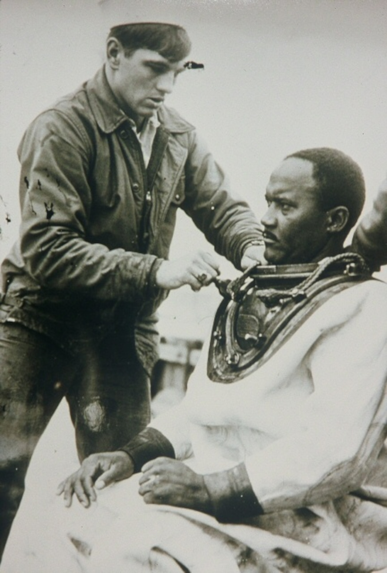 In this undated photo, a U.S. Navy Sailor fits Carl Brashear, the first African-American U.S. Navy diver, with a diving suit prior to a training mission. After recovering from a diving incident that resulted in the amputation of his left leg below the knee, Brashear returned to service, becoming the first African-American to be certified as a U.S. Navy master diver. Brashear retired in 1979 as a master chief petty officer. (Photo courtesy/Chief Warrant Officer 4 Phillip Brashear) (RELEASED)