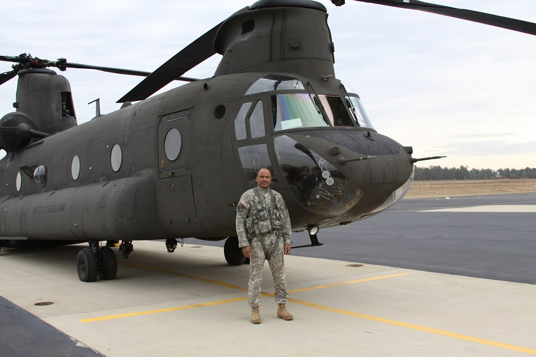 FORT EUSTIS, Va. -- In this undated photo, U.S. Army Chief Warrant Officer Phillip Brashear, Company B, 5/159th Aviation Regiment Chinook pilot, stands in front a Chinook helicopter at Felker Army Airfield. Chief Brashear is the son of the late Carl Brashear, the first African-American U.S. Navy diver. Chief Brashear said his father inspired him to serve his country through his resiliency in the face of racial discrimination, socio-economic hardship and physical handicap. (Photo courtesy/Chief Warrant Officer 4 Phillip Brashear) (RELEASED)