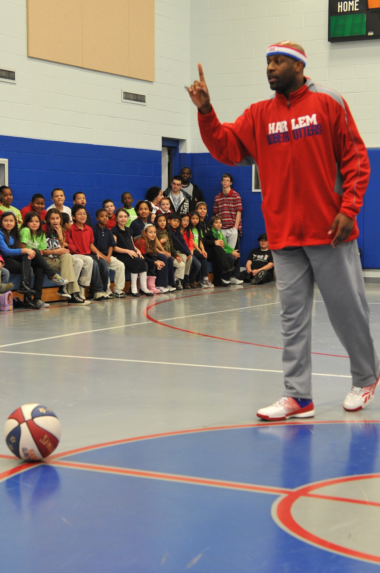 Harlem Globetrotter Aundre “Hot Shot” Branch talks to the Youth Center kids, at Little Rock Air Force Base, Ark., Jan. 21, 2011. As a Harlem Globetrotter, Hot Shot’s responsibilities is to reach out to the fans, and talked to them about what it takes to be a Harlem Globetrotter. (U.S. Air Force photo by Airman 1st Class Rusty Frank)