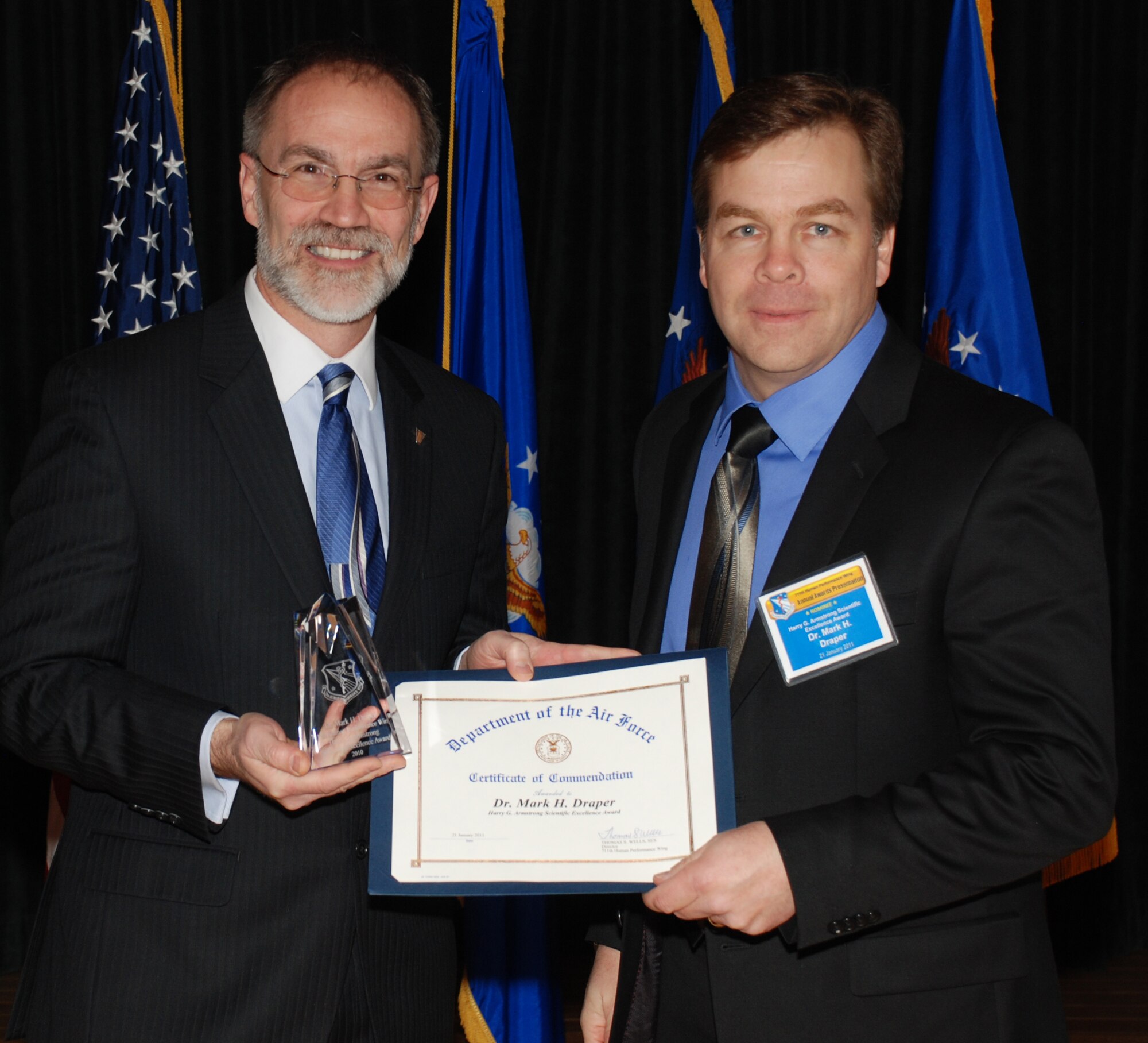Mr. Thomas Wells (left), director of the Air Force Research Laboratory’s 711th Human Performance Wing (711 HPW), presents the Harry G. Armstrong Scientific Excellence Award to 2010 winner Dr. Mark Draper, senior research engineering psychologist with the Human Effectiveness Directorate’s Warfighter Interface Division, Supervisory Control Interfaces Branch, January 21 at the HPW’s annual awards luncheon.