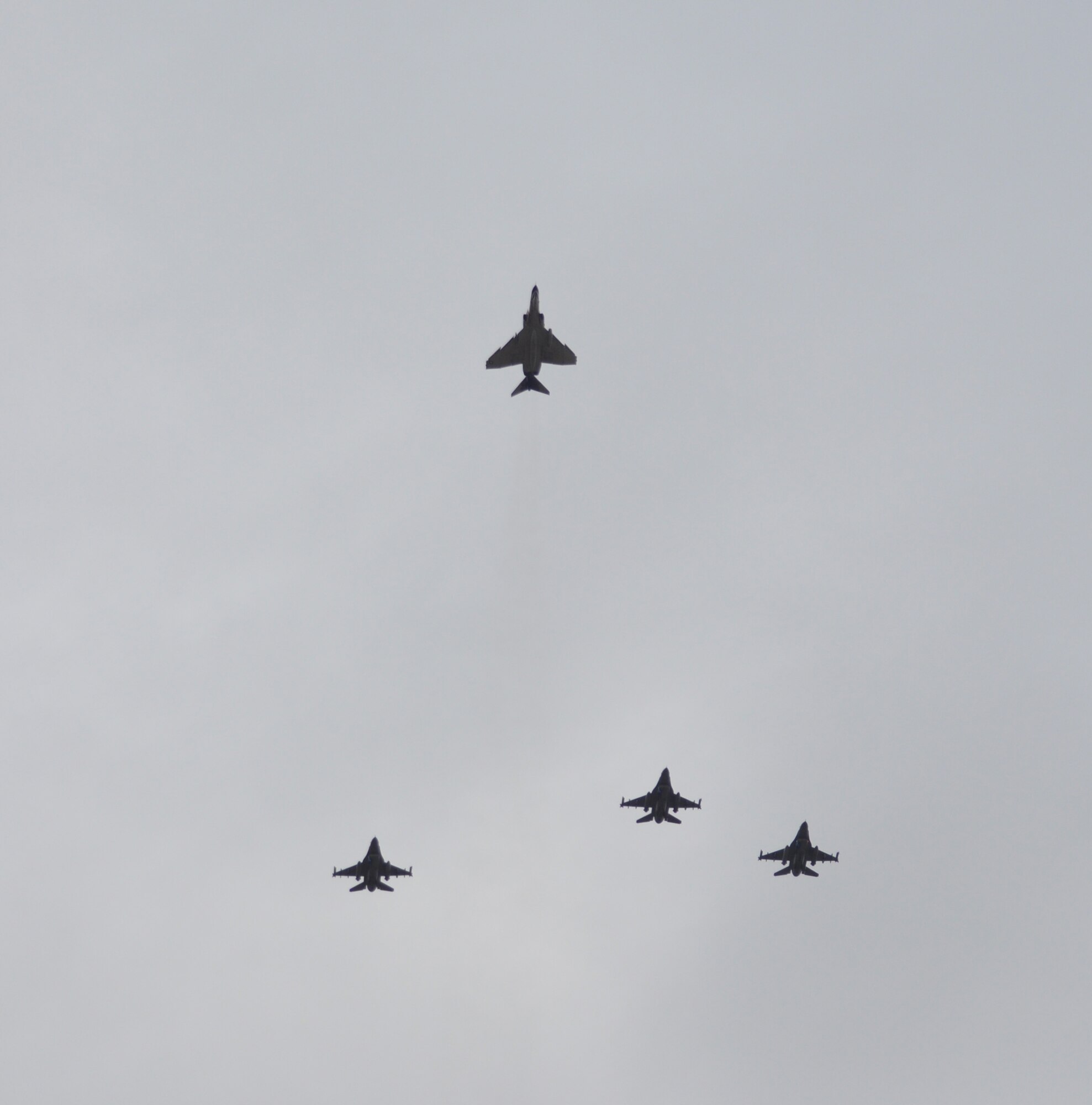 Three F-16s from the 301st Fighter Wing, Naval Air Station Fort Worth Joint Reserve Base, Texas, and an F-4 from Detachment 1, 82nd Aerial Targets Squadron, Holloman Air Force Base, N.M., fly the missing man formation over a memorial service Jan. 14, 2011 at Dallas-Fort Worth National Cemetery. The service honored Col. James E. Dennany and Maj. Robert L. Tucci, who were reported missing in action after their F-4 went down during a mission over Laos Nov. 12, 1969. (U.S. Air Force photo/SrA Melissa Harvey)