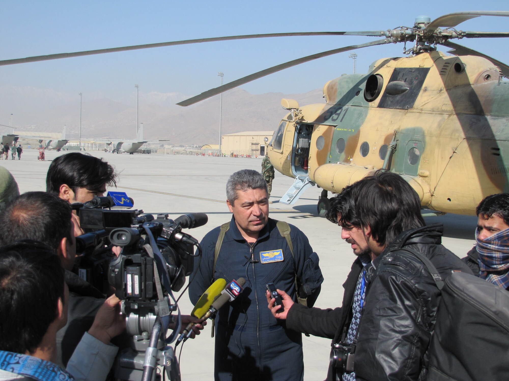 Members of the media interview an Afghan Mi-17 transport helicopter pilot Jan. 24, as the Afghan Air Force Public Affairs conducted their first media day.  (U.S. Air Force photo/Capt. Rob Leese) RELEASED.
