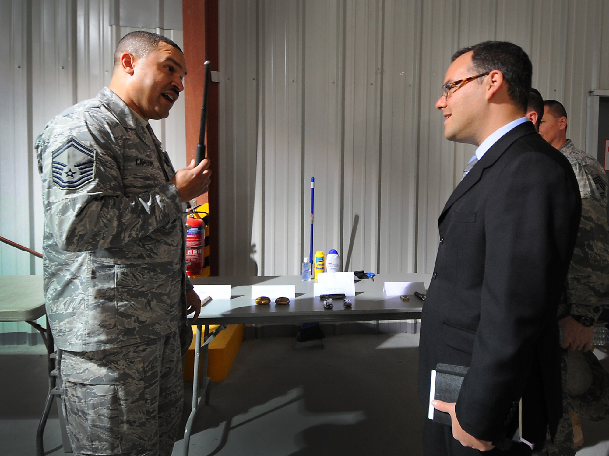Senior Master Sgt. Andre Cameron talks to the Assistant Secretary of the Air Force for Manpower and Reserve Affairs, Daniel B. Ginsberg, about the new all Air Force Customs recently started here Jan. 19. Mr. Ginsberg met with 386th Air Expeditionary Wing Airmen at all levels to discuss pertinent manpower and readiness issues and to answer questions on topics such as force shaping and the Don't Ask, Don't Tell policy. Sergeant Cameron is assigned to the 386th Expeditionary Logisitics Readiness Squadron.  (U.S. Air Force photo by Senior Airman Cynthia Spalding)
