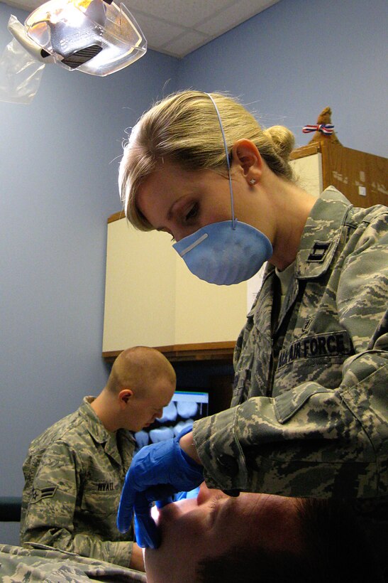 GRISSOM AIR RESERVE BASE, Ind. -- Capt. (Dr.) Kathryn Dahlen, 434th Aerospace Medicine Squadron dentist, examines Staff Sgt. Leif Olson, 434th Maintenance Group quality assurance technician, while Airman 1st Class Joseph Hyatt, 434th AMDS dental assistant apprentice, charts her findings. Captain Dahlen is one of three new dentists at Grissom. (U.S. Air Force photo/Capt. Kelly Howard)                                              