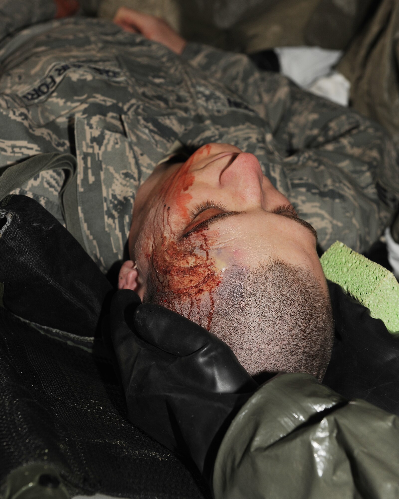 KUNSAN AIR BASE, Republic of Korea -- An 8th Medical Group Airman holds a patient’s head steady while decontamination procedures are conducted here Jan. 25 during the peninsula-wide exercise Beverly Bulldog 11-01. The exercise provides hands-on training to medical personnel while using decontamination procedures to enhance readiness for the 8th Fighter Wing’s upcoming Operational Readiness Inspection. (U.S. Air Force photo/Senior Airman Ciara Wymbs) 