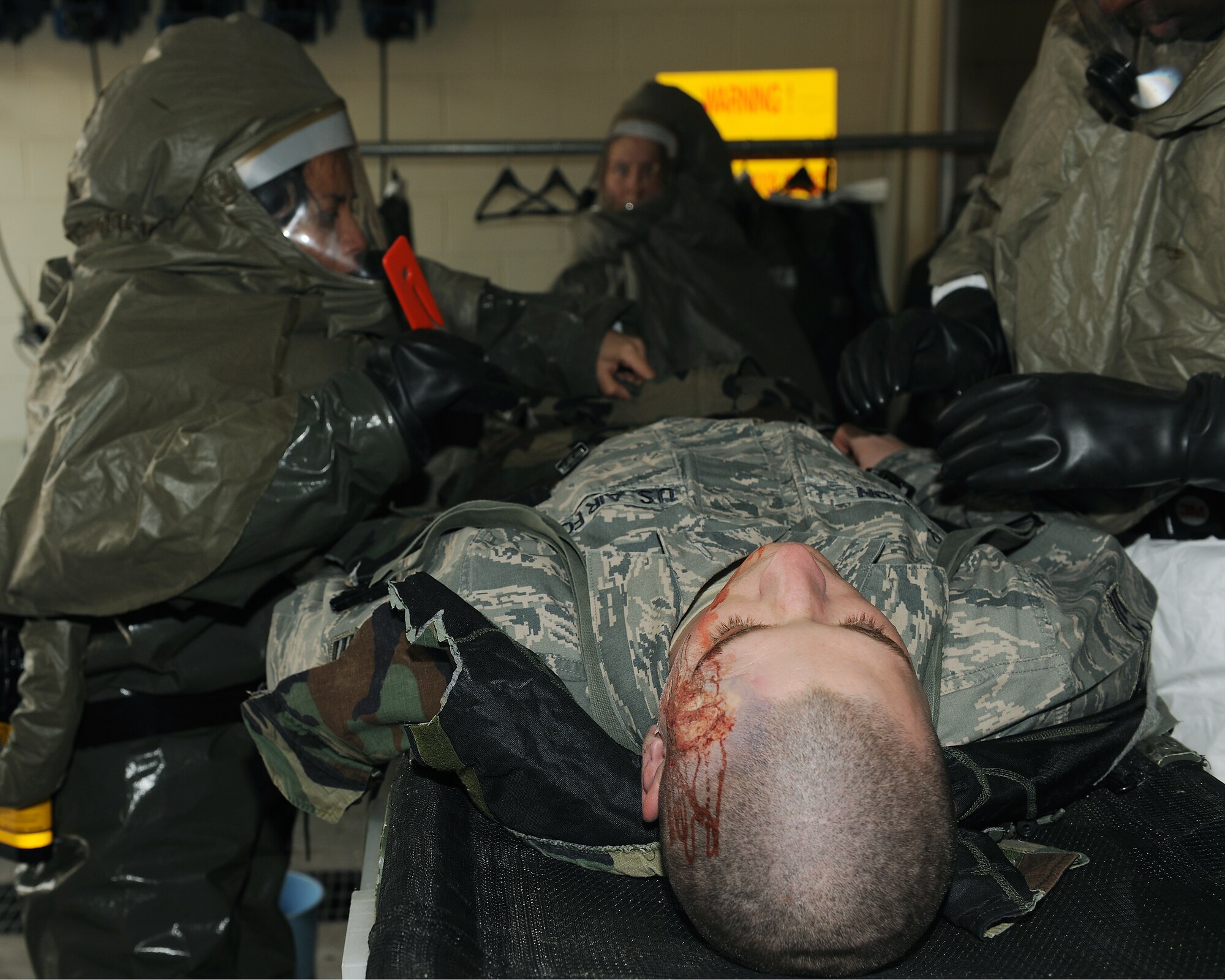KUNSAN AIR BASE, Republic of Korea -- Staff Sgt. Monica Lampano, 8th Medical Support Squadron, cuts the clothing from a patient at the decontamination point here Jan. 25 during the peninsula-wide exercise Beverly Bulldog 11-01. Wolf Pack Airmen are currently participating in the exercise to prepare for the 8th Fighter Wing's Operational Readiness Inspection. (U.S. Air Force photo/Senior Airman Ciara Wymbs) 