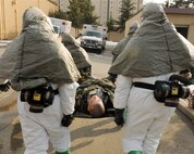 KUNSAN AIR BASE, Republic of Korea -- Airmen from the 8th Medical Group transport a patient to the decontamination point here Jan. 25 during the peninsula-wide exercise Beverly Bulldog 11-01. The exercise provides hands-on training to medical personnel while using decontamination procedures to enhance readiness for the 8th Fighter Wing’s upcoming Operational Readiness Inspection. (U.S. Air Force photo/Senior Airman Ciara Wymbs) 