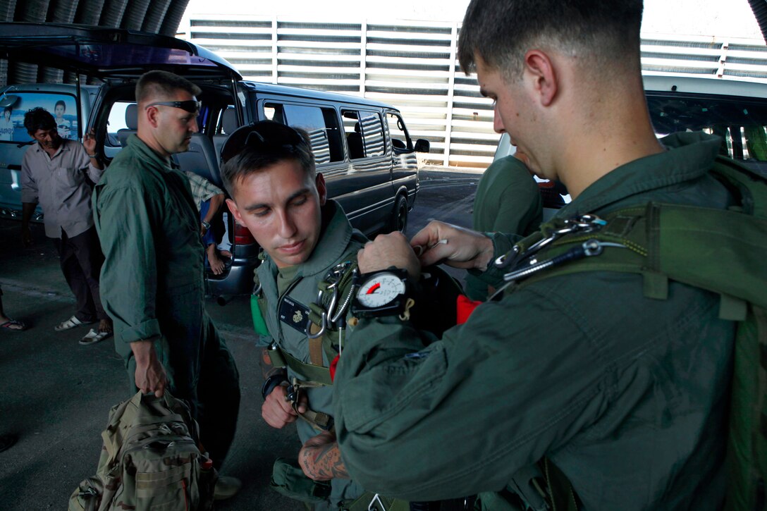 U.S. Marines inspect their gear and make final preparations before conducting jump training during Cobra Gold on U-Tapao Royal Thai Navy Airfield in Chonburi province, Thailand, Jan. 21, 2011. The Marines, assigned to Force Reconnaissance Company, 3rd Reconnaissance Battalion, took part in bilateral jump training with a Royal Thai Marine Corps reconnaissance team. Cobra Gold is a regularly-scheduled joint exercise to ensure regional peace and strengthen the ability of Thai forces to defend Thailand and respond to regional contingencies.