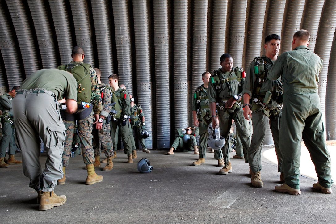 U.S. Marines inspect their gear and make final preparations before ...