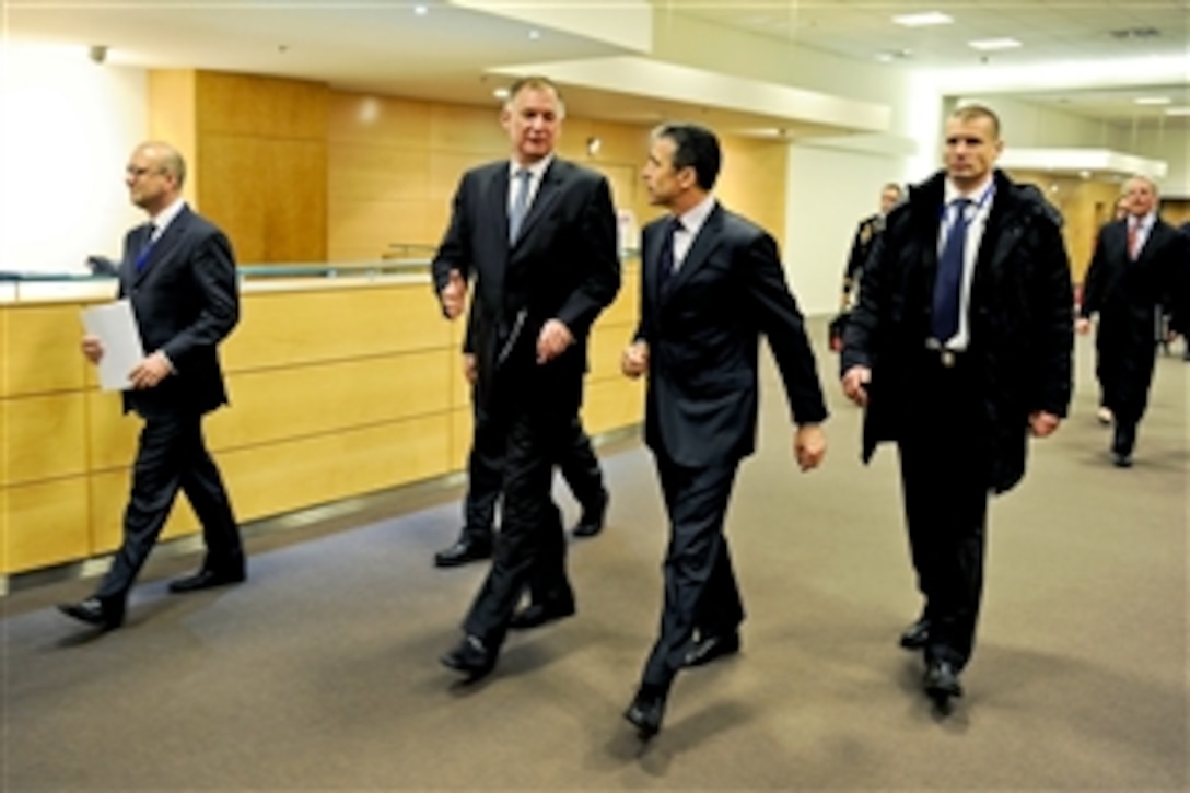 U.S. Deputy Defense Secretary William J. Lynn III and NATO Secretary General Anders Fogh Rasmussen, second from right, walk to a meeting with national policy advisors on NATO cyber defense at NATO headquarters in Brussels, Belgium, Jan. 25, 2011.