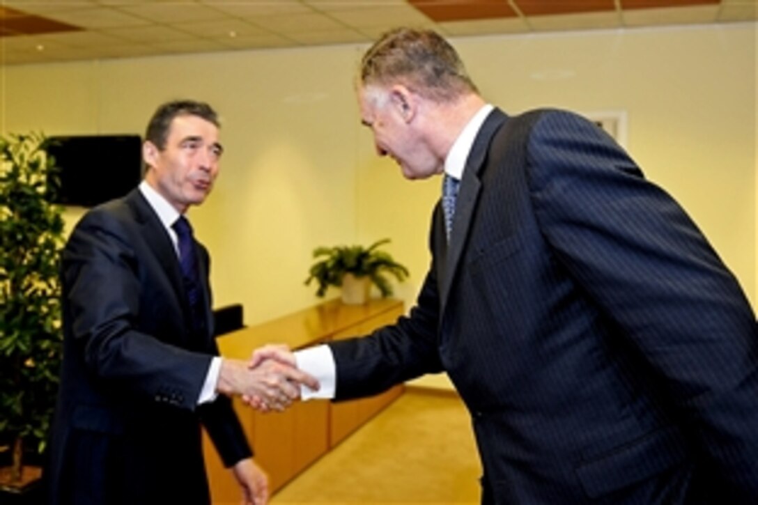 U.S. Deputy Defense Secretary William J. Lynn III shakes hands with NATO Secretary General Anders Fogh Rasmussen at NATO headquarters in Brussels, Belgium, Jan. 25, 2011.