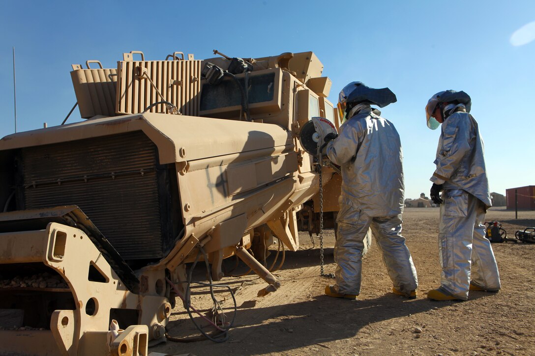 Crash, Fire and Rescue Marines with Marine Wing Support Squadron 373, 3rd Marine Aircraft Wing (Forward), practice rescue procedures on an up-armored vehicle aboard Camp Leatherneck, Afghanistan, Jan. 25.  The Marines, assigned to the Tactical Response Team, train on unserviceable vehicles to prepare for real-life scenarios and receive hands-on experience with their equipment.
