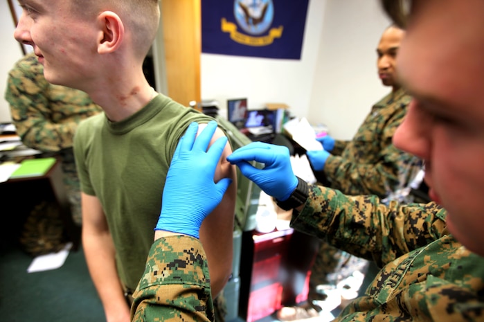 Lance Cpl. Corey M. Ayers, a motor transportation operator with 2nd Marine Logistics Group (Forward), receives a smallpox vaccine at the Combined Aid Station aboard Camp Lejeune, N.C., Jan. 26, 2010.  The corpsmen at the CAS have the arduous task of keeping track of medical records, making sure the Marines and sailors are up to date with their vaccines and ensuring the Group is ready to deploy. (U.S. Marine Corps photo by Lance Cpl. Bruno J. Bego)