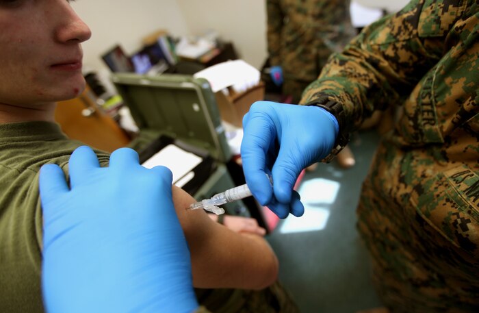 Lance Cpl. Corey M. Ayers, a motor transportation operator with 2nd Marine Logistics Group (Forward), receives an anthrax vaccine at the Combined Aid Station aboard Camp Lejeune, N.C., Jan. 26, 2010.  The corpsmen at the CAS have the arduous task of keeping track of medical records, making sure the Marines and sailors are up to date with their vaccines and ensuring the Group is ready to deploy.  (U.S. Marine Corps photo by Lance Cpl. Bruno J. Bego)